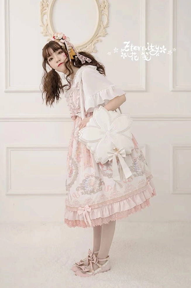 White sakura cherry blossom shoulder lolita handbag carried on shoulder with pink ruffled dress dreamy print full-body side view