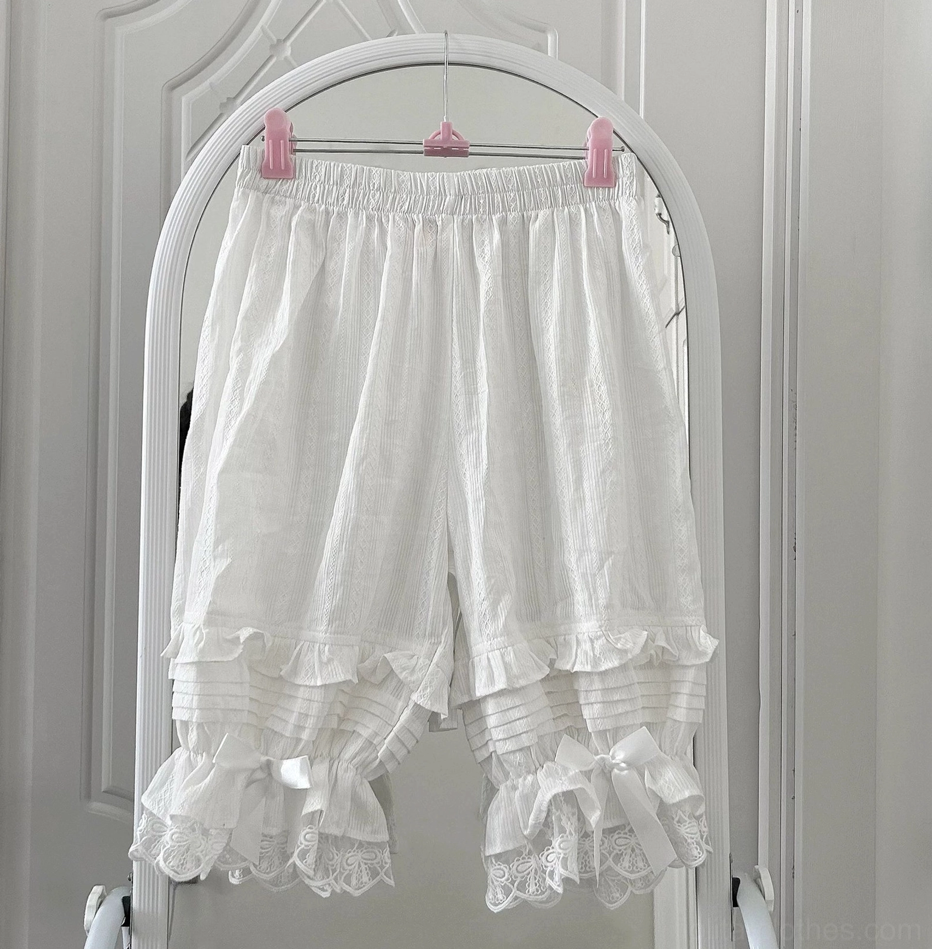 White short-length sweet lolita bloomers with accordion pleats lace ruffles and satin bow accents perfect for petite frames and shorter lolita skirts styling