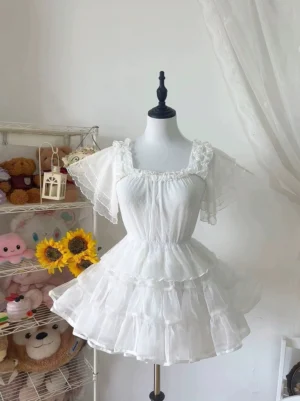 White square-neck Lolita blouse with three-tiered ruffled flutter sleeves and back tie detail, three-quarter view on mannequin