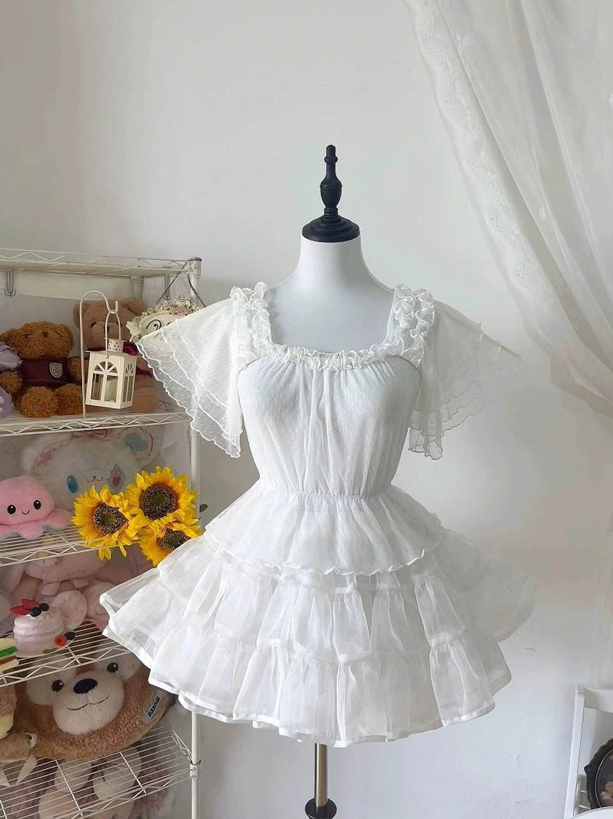 White square-neck Lolita blouse with three-tiered ruffled flutter sleeves and back tie detail, three-quarter view on mannequin