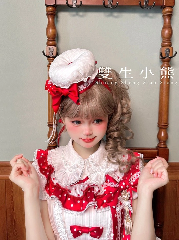 Sweet lolita blouse bubble sleeve and shoulder extension detail showing delicate ruffled edge and doll-like silhouette construction on dress form display