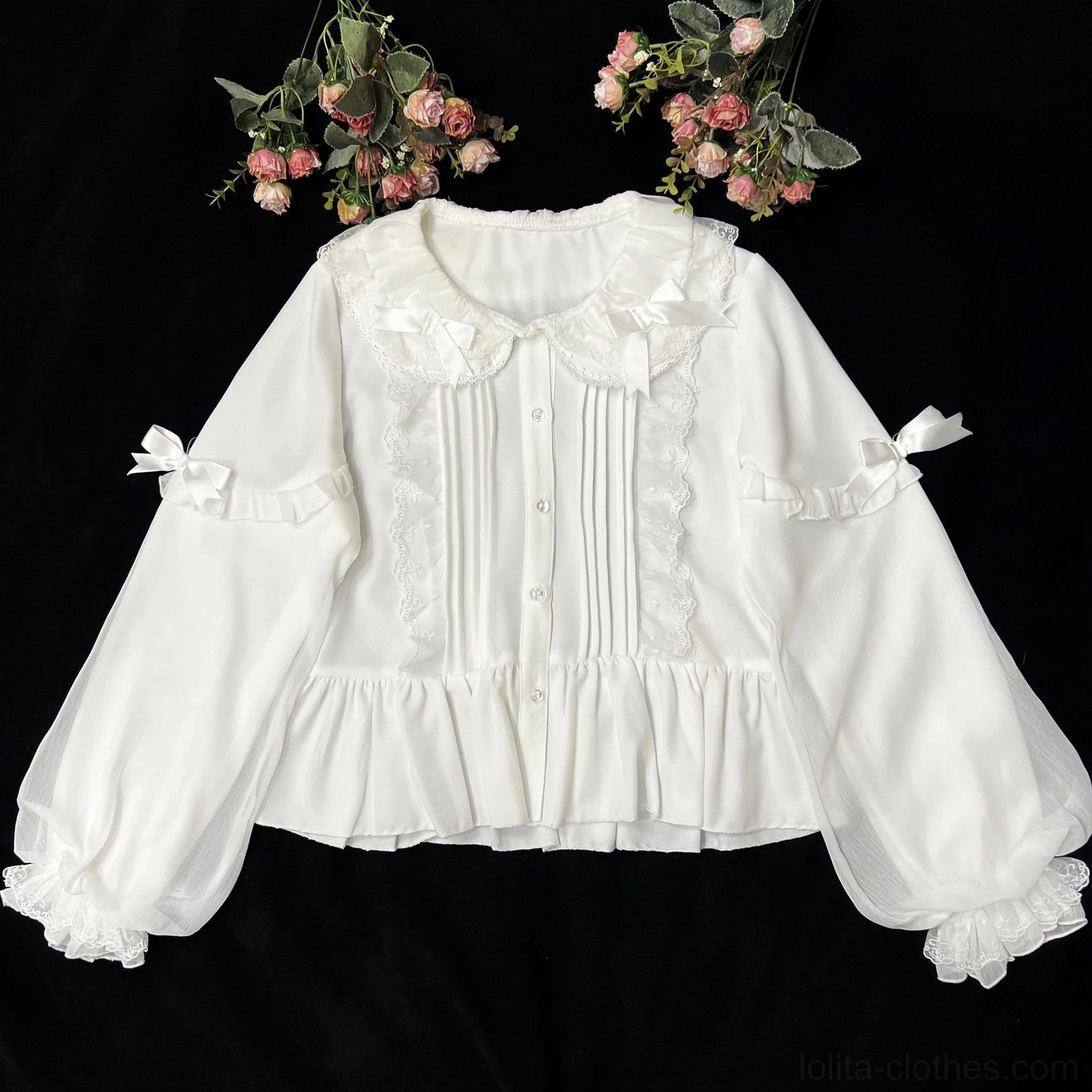 Milky white sweet Lolita blouse with Peter Pan collar and double-layered puff sleeves featuring front lace pintucks, sleeve bows and ruffled cuffs - flat lay overhead view with artificial roses on black background