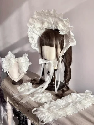 Pure white sweet lolita bonnet with matching lace accessories featuring all-white ruffled lace design and soft satin bow details on vintage vanity