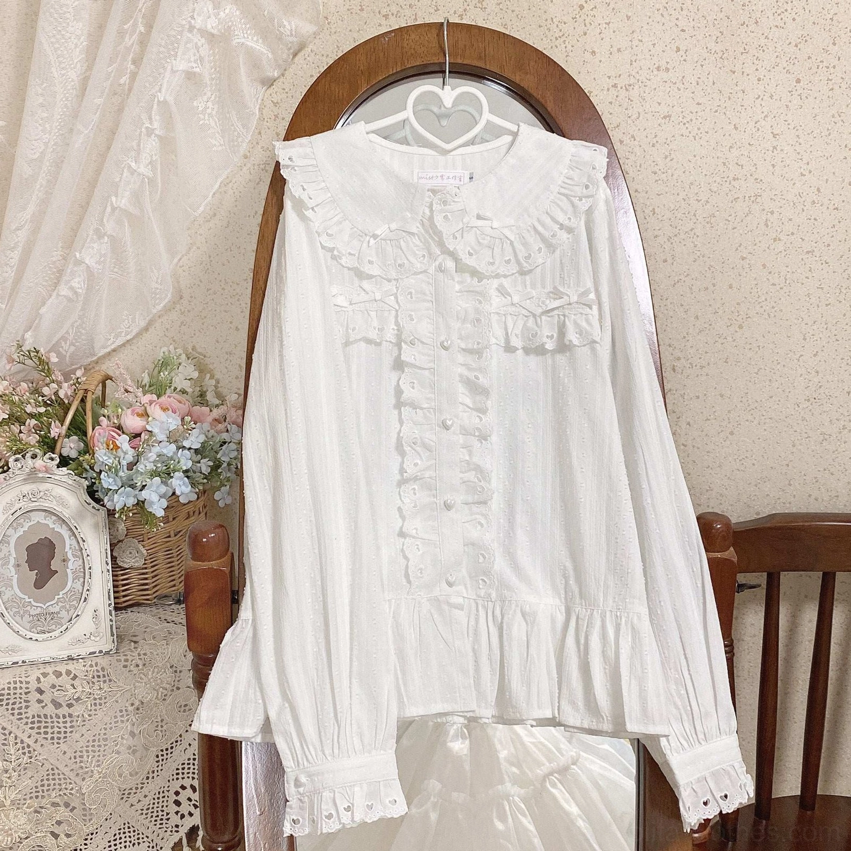 Plain white sweet lolita long-sleeve doll collar blouse with ruffled front placket and puff sleeves hanging view