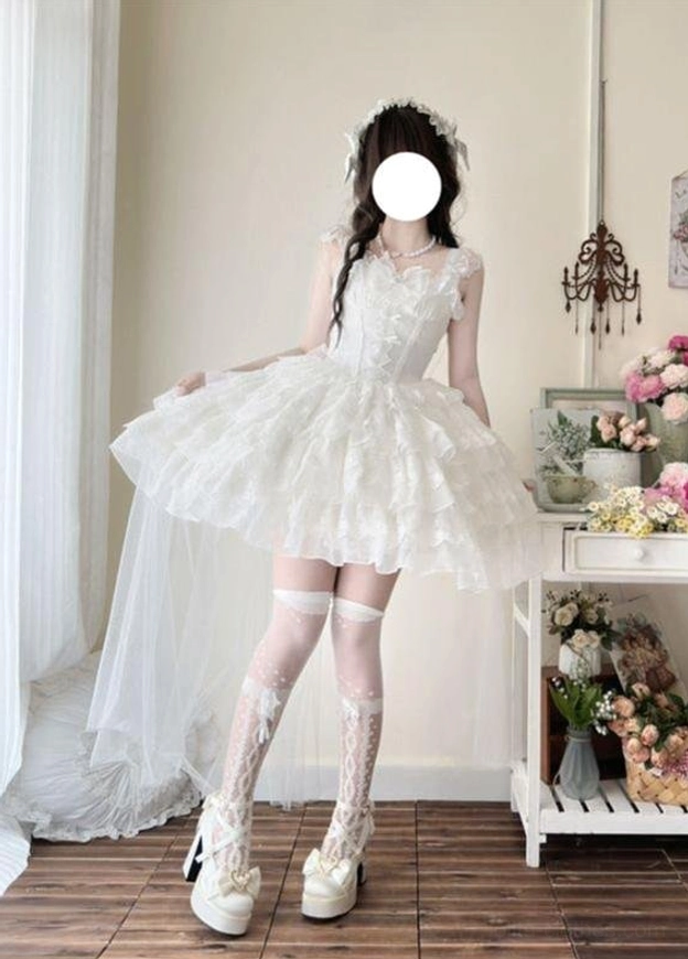 White sweet lolita wedding JSK with removable long tulle train, side three-quarter view showing layered ruffled skirt and lace details