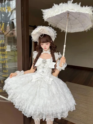 White wedding sweet lolita JSK dress with multi-layered lace ruffled skirt, twin-braid hairstyle, lace bonnet, and feathered umbrella - front full body view