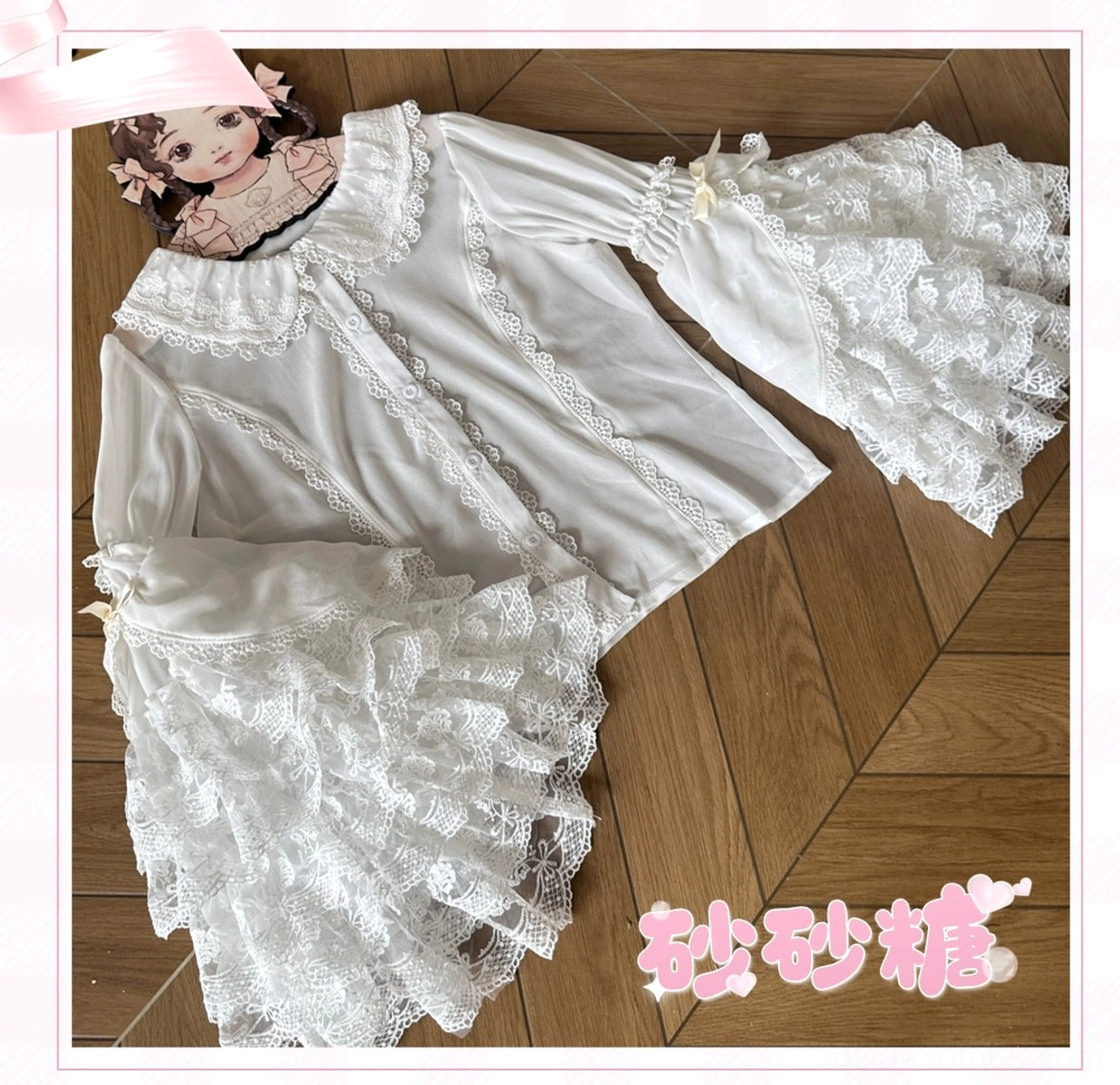 White Sweet Lolita lace blouse flat lay overhead view Peter Pan collar button placket ribbon cuffs