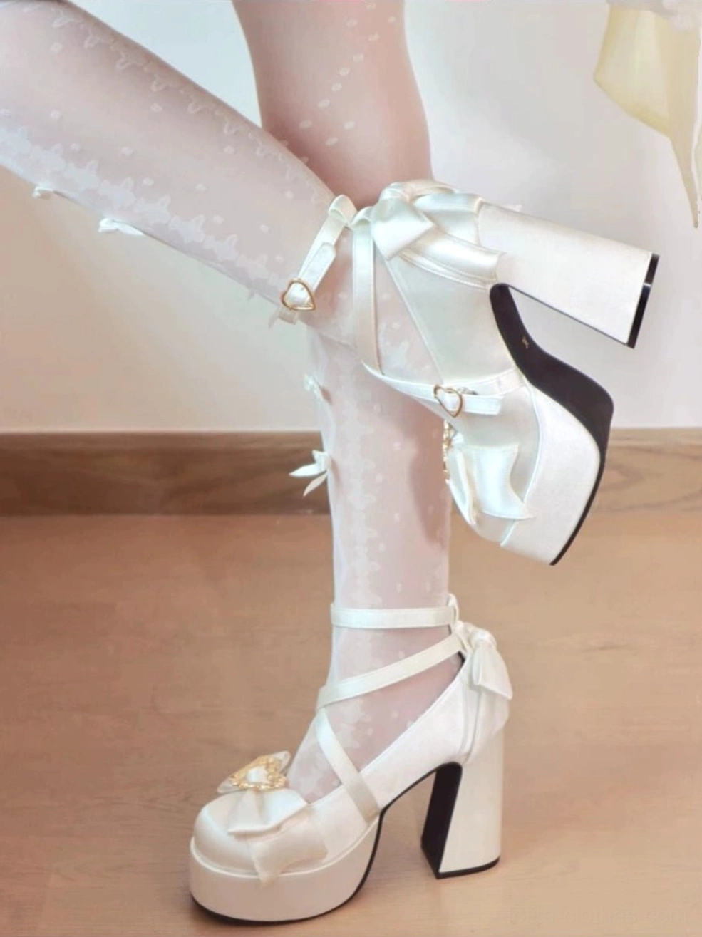 White Sweet Lolita Mary Jane heart heels with bow ankle strap on model feet side close up view wooden floor background
