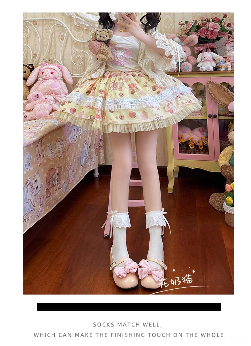 White sweet lolita mid-calf socks worn with yellow floral sweet lolita dress, mirror selfie seated view in doll-themed bedroom