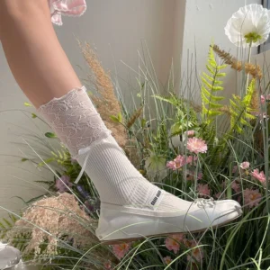 White sweet lolita patchwork lace ruffled socks with bow accent mid-calf sock outdoor floral background