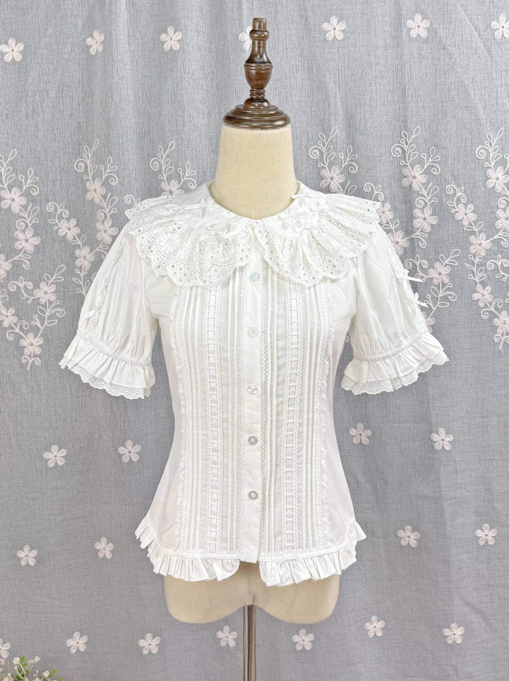 White Sweet Lolita Peter Pan collar blouse with hollow embroidered ruffled neckline front flat display view on wooden mannequin