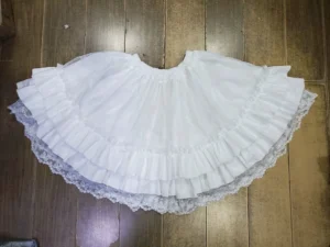 White sweet lolita underskirt petticoat overhead flat lay view wooden floor double-layered ruffled hem lace edging elastic waist cotton lining