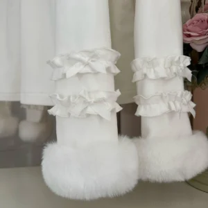 Close-up detail of white lolita top layered ruffled frills satin bow decorations and thick fluffy faux fur sleeve cuff trim
