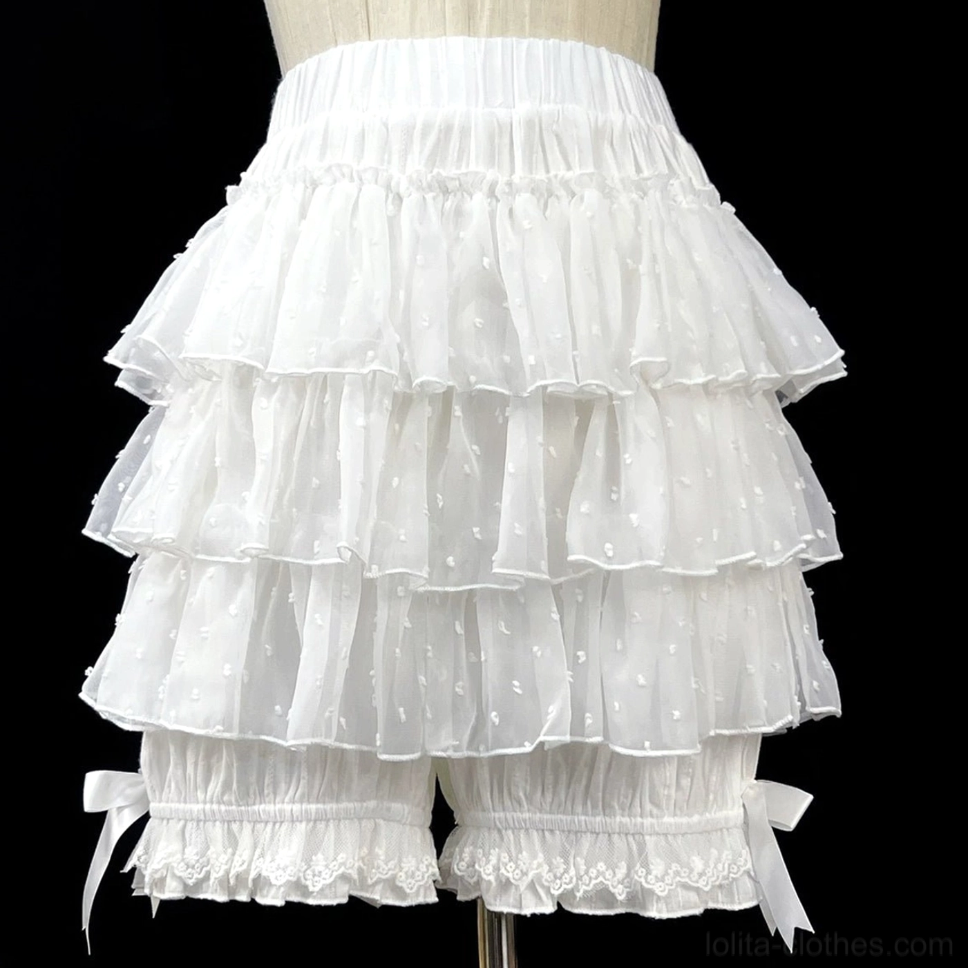 White tiered ruffle lolita bloomers three-quarter front view on dress form showcasing sheer dotted fabric ruffles elastic waistband decorative lace-trimmed leg openings and ribbon bows
