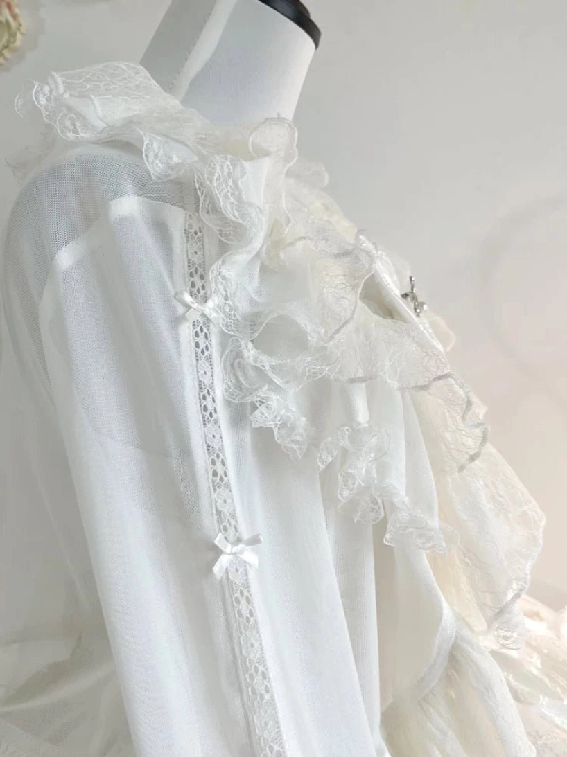 Close-up detail of white tulle lolita bolero sheer fabric, lace ruffle collar, tiny satin bows and lace trim on front placket, dress form side view