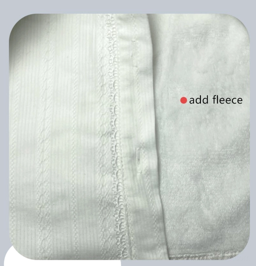 Close-up flat lay detail of white fleece-lined velvet lolita blouse fabric showing vertical stripe texture, delicate lace trim along button placket, and soft plush fleece inner lining marked add fleece