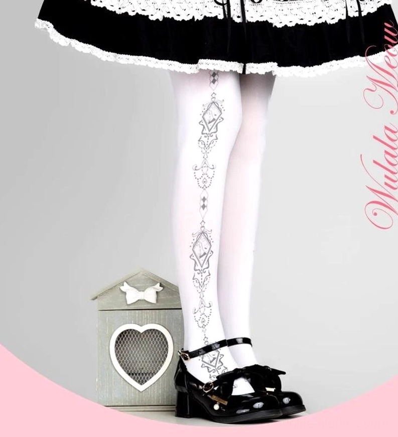 White velvet Lolita pantyhose with black vintage diamond vine prints worn with black Mary Jane shoes and frilly Lolita skirt low angle leg view
