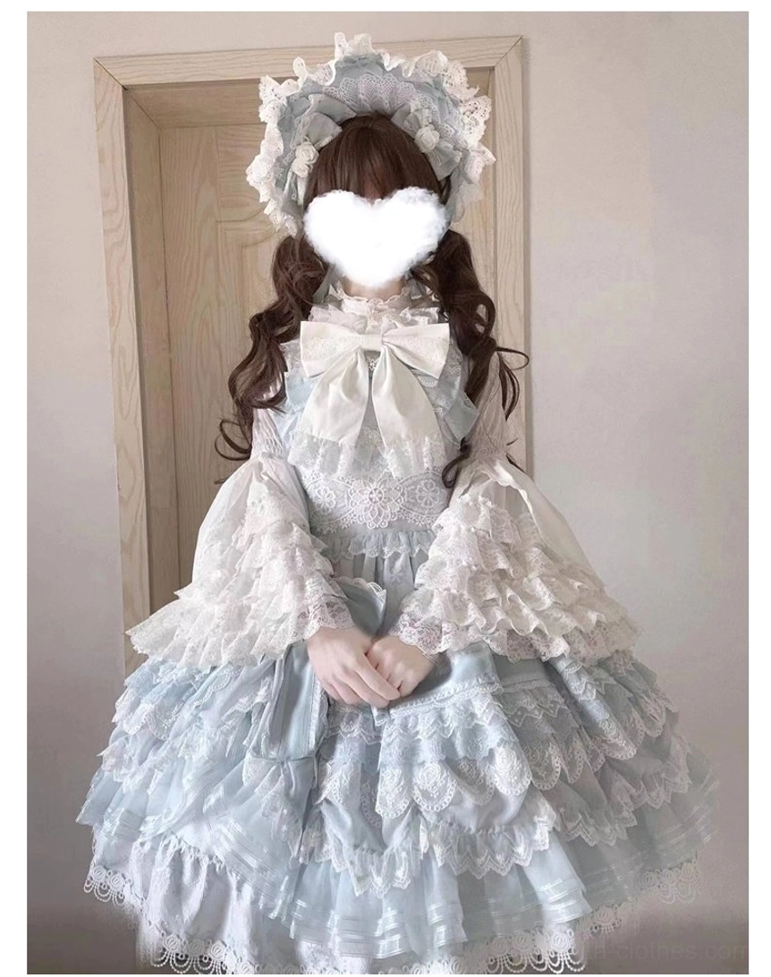 Pure white vintage-inspired Lolita dress with princess blouse, long lace trumpet sleeves, front big bow, and trailing lace-trimmed tulle skirt, full-body seated view