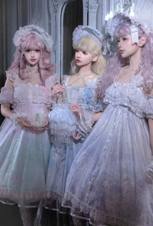 Three sweet lolita models wearing coordinated pastel gradient OP dresses with matching jellyfish-themed headdresses and ruffled accessories in vintage European mansion setting