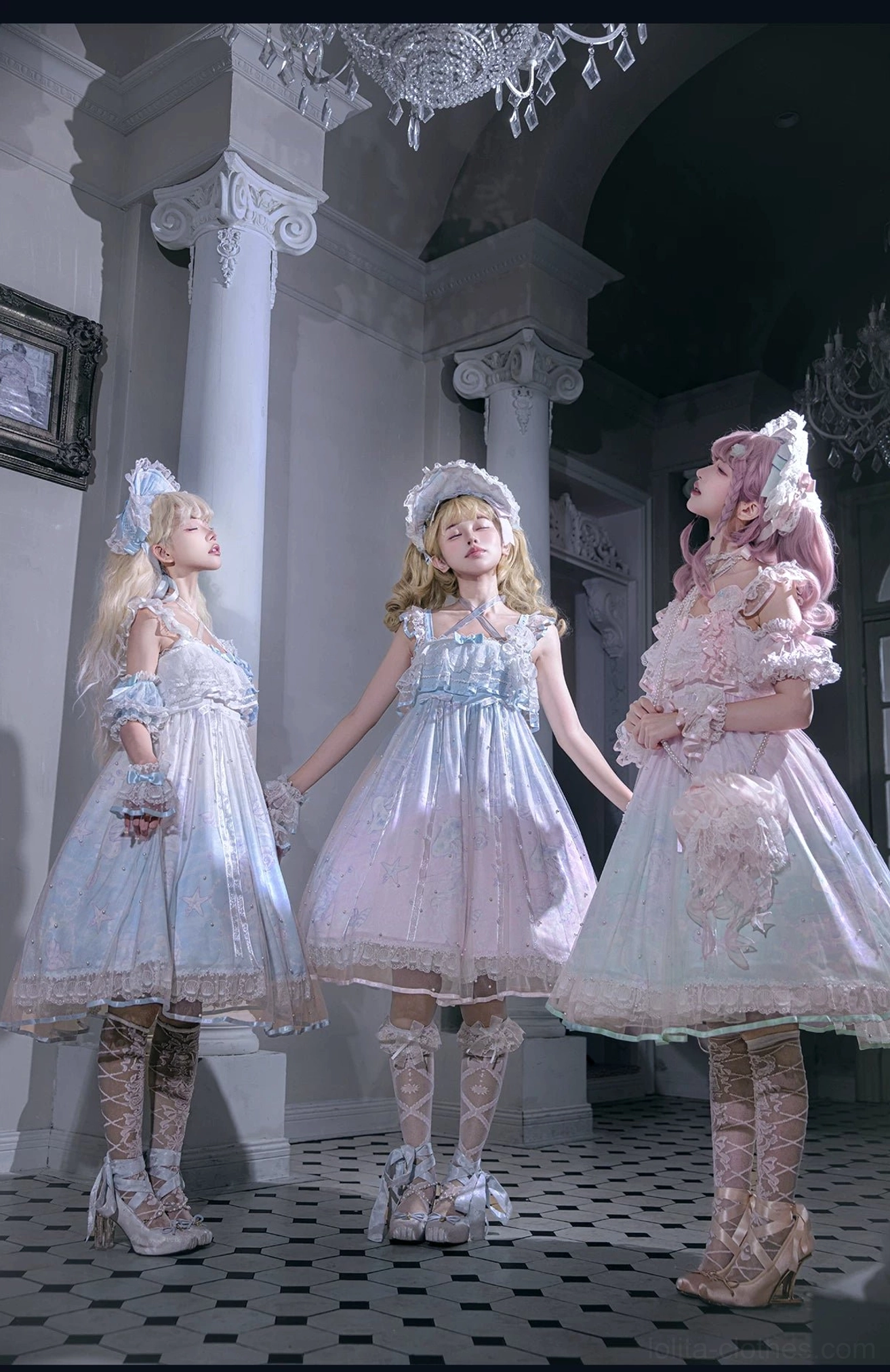 Three lolita models in short-length sweet OP dresses with ruffled shoulder straps and gradient pastel skirt designs in vintage European mansion indoor space