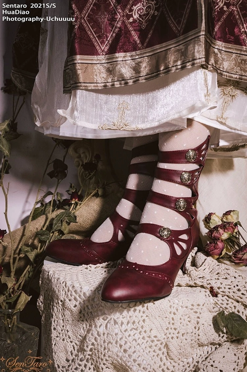 Wine red floral hollow-out Mary Jane lolita flat shoes on lace-covered table paired with Lolita skirt and dried botanical decorations