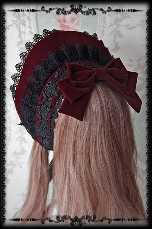 Wine red Gothic Lolita velvet bonnet featuring black lace frills and prominent wine red velvet back bow, rear viewing angle detail