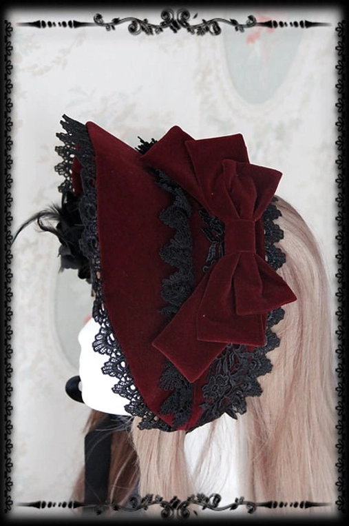 Wine red velvet Gothic Lolita bonnet with black lace trim and large wine red velvet side bow, right rear angle showing bow placement