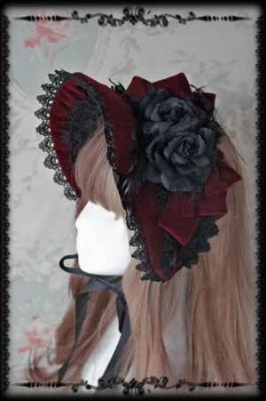 Wine red Gothic Lolita velvet bonnet featuring black lace trim and large black fabric rose bow accent, left side model wearing perspective