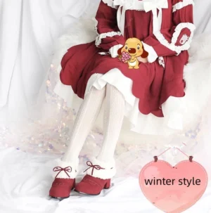 Kawaii lolita winter ankle boots in wine red suede with white fleece collar and red bow accents on high-angle model view