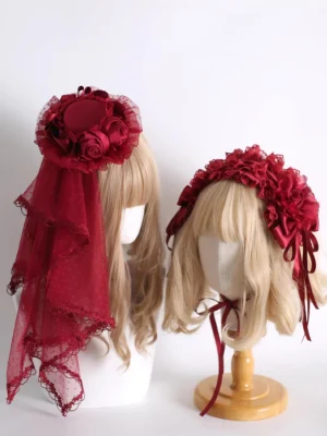 Wine red Lolita headdress collection flat lay featuring complete accessory set with satin roses, ruffled lace mesh veil, multiple hair clips, and coordinating choker pieces on white background