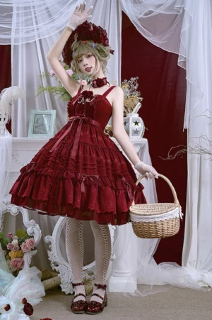Wine red elegant Lolita jumper dress full body front view with model wearing flower hat and rose choker, featuring multi-layer ruffled skirt with bow trims in vintage European studio setting