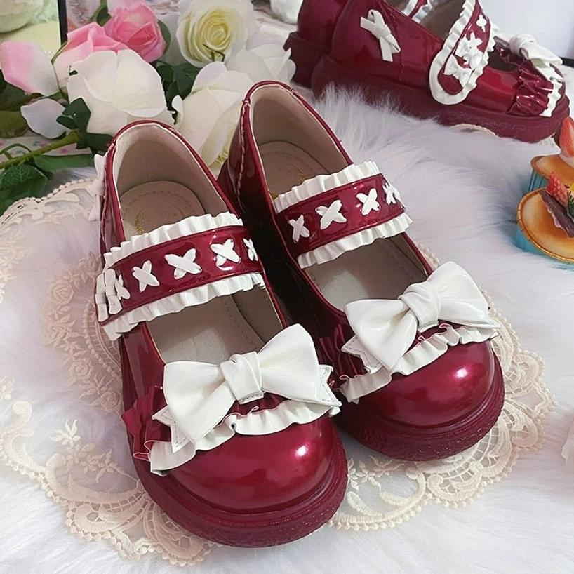 Wine red Lolita shoes detailed product photography showcasing rich jewel tone color, glossy patent leather finish, decorative elements and platform construction