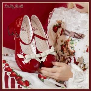 Wine red patent leather Mary Jane Lolita shoes with white butterfly bow vamp displayed overhead against strawberry print Lolita dress backdrop with polka dot branded insole visible