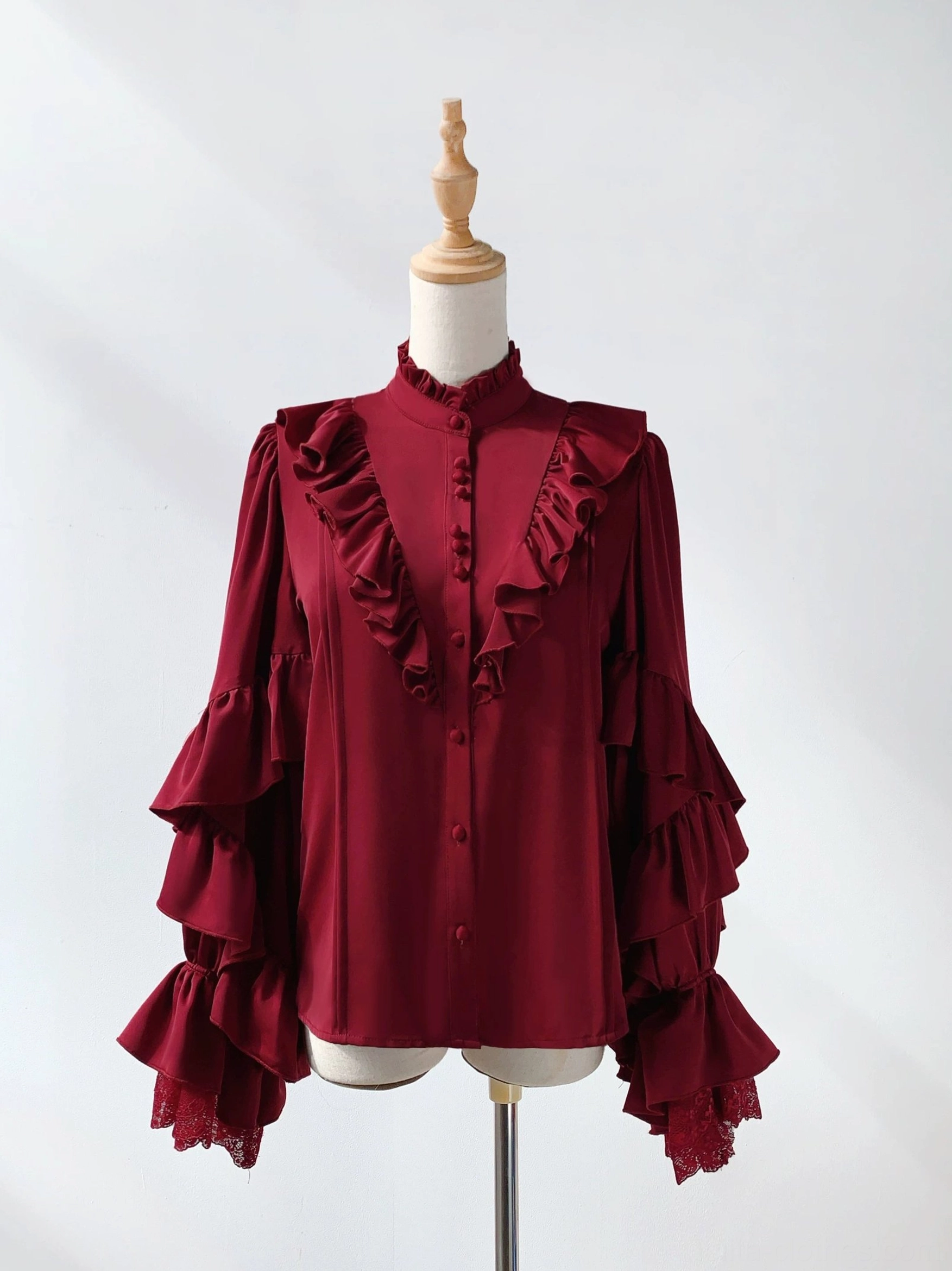 Wine red Ouji Lolita satin princess sleeve blouse front flat lay white studio background layered flared lace-trimmed sleeves