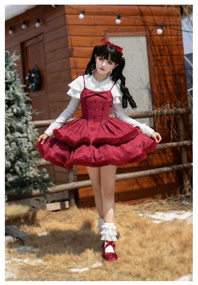 Single lolita model wearing wine red winter slip dress with spaghetti strap tiered ruffle skirt, white long-sleeve knit inner top, red Mary Jane shoes, ruffled socks in snowy yard