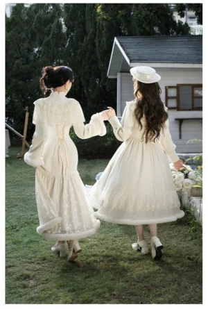 Winter Island Memory lolita coat and dress set back view dual model showing cape silhouette faux fur trim fuzzy skirt hem vintage garden setting