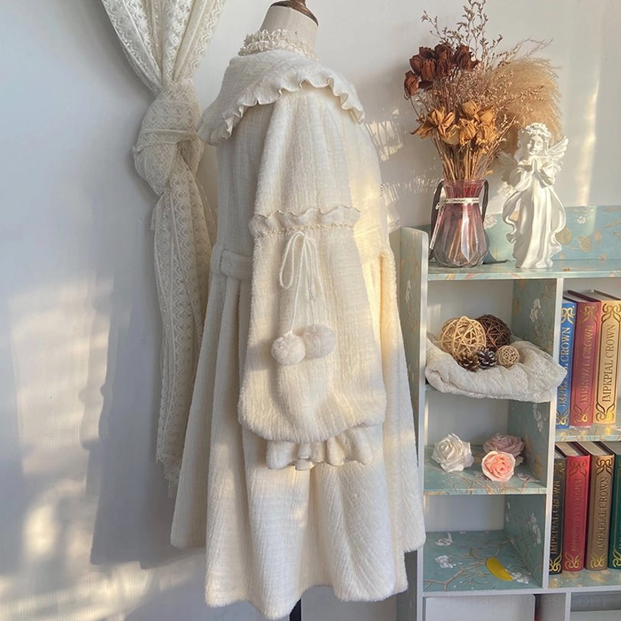 Close-up texture and craftsmanship of fluffy gold sable fabric used in cream lolita winter coat showing plush material quality and stitch details