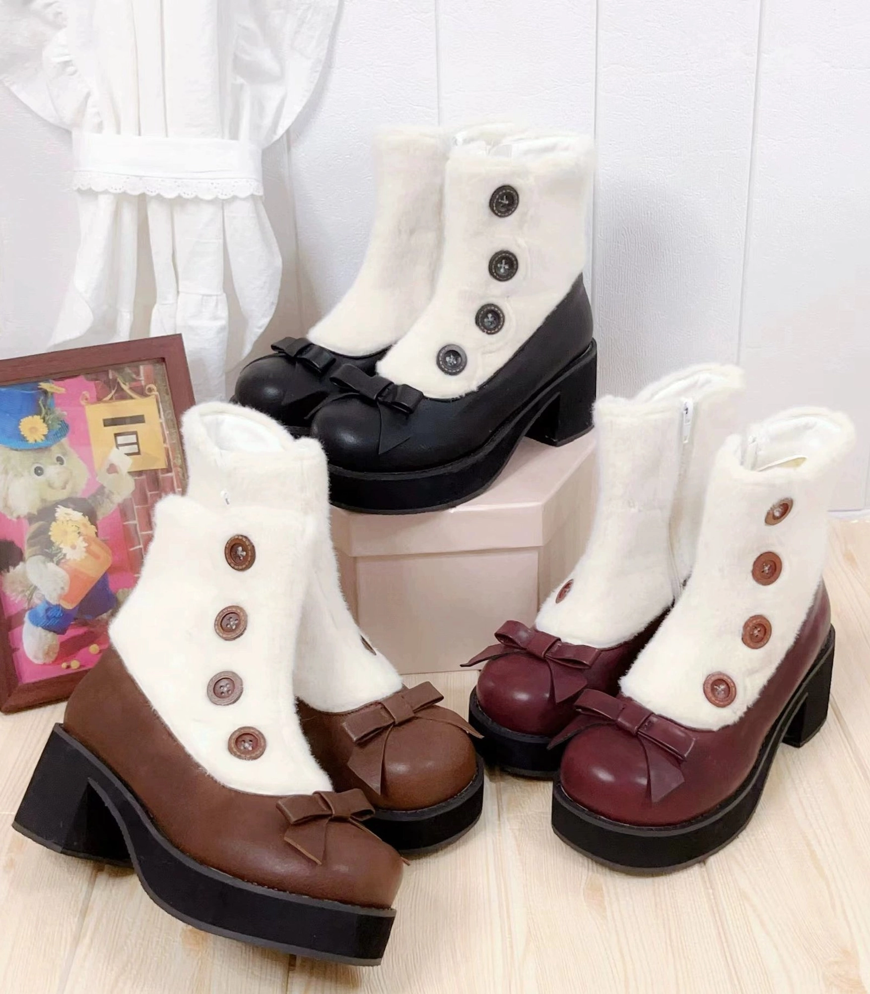 Winter lolita mary jane boots with faux fur collar and bow details in black brown and wine red colors overhead flat lay view with decorative elements