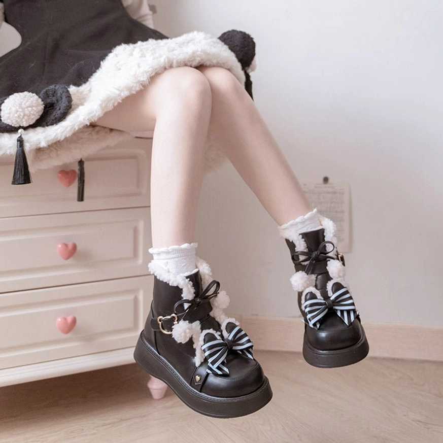 Fuzzy fur collar pom-pom trim on winter lolita snow boots soft plush texture cute adorable accent detail close-up view