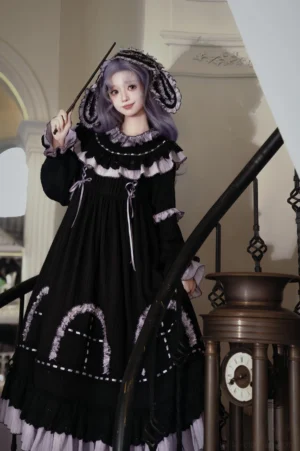 Close-up three-quarter front detail of Witch Lilith OP showing ruffled doll collar, drawstring waist, lantern sleeves with lace cuffs, model holding magic wand on staircase