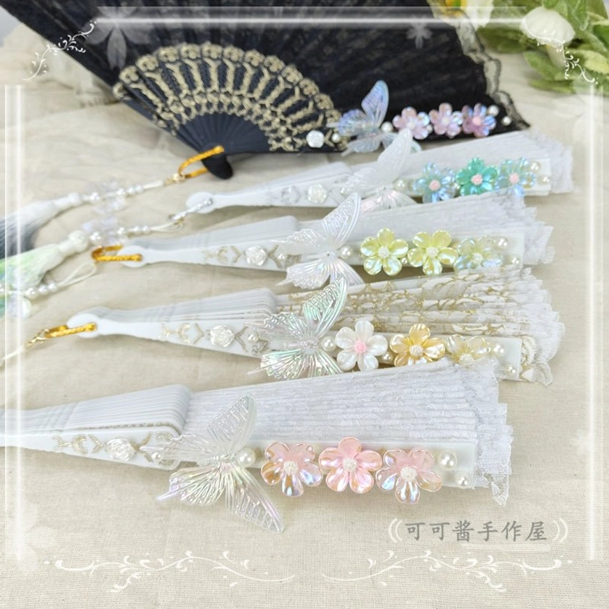 Yellow-green spring lolita folding fan with fresh floral aesthetic white butterfly ornament and nature-inspired green gradient tassel