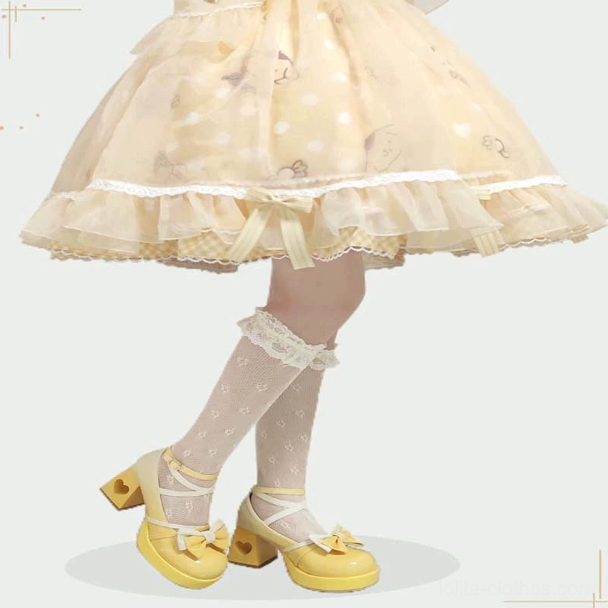 Front low-angle product shot of yellow Lolita platform heels with rounded toe bow, heart block heel, and platform sole paired with lace-trim knee-high socks and ruffled Sweet Lolita tutu dress