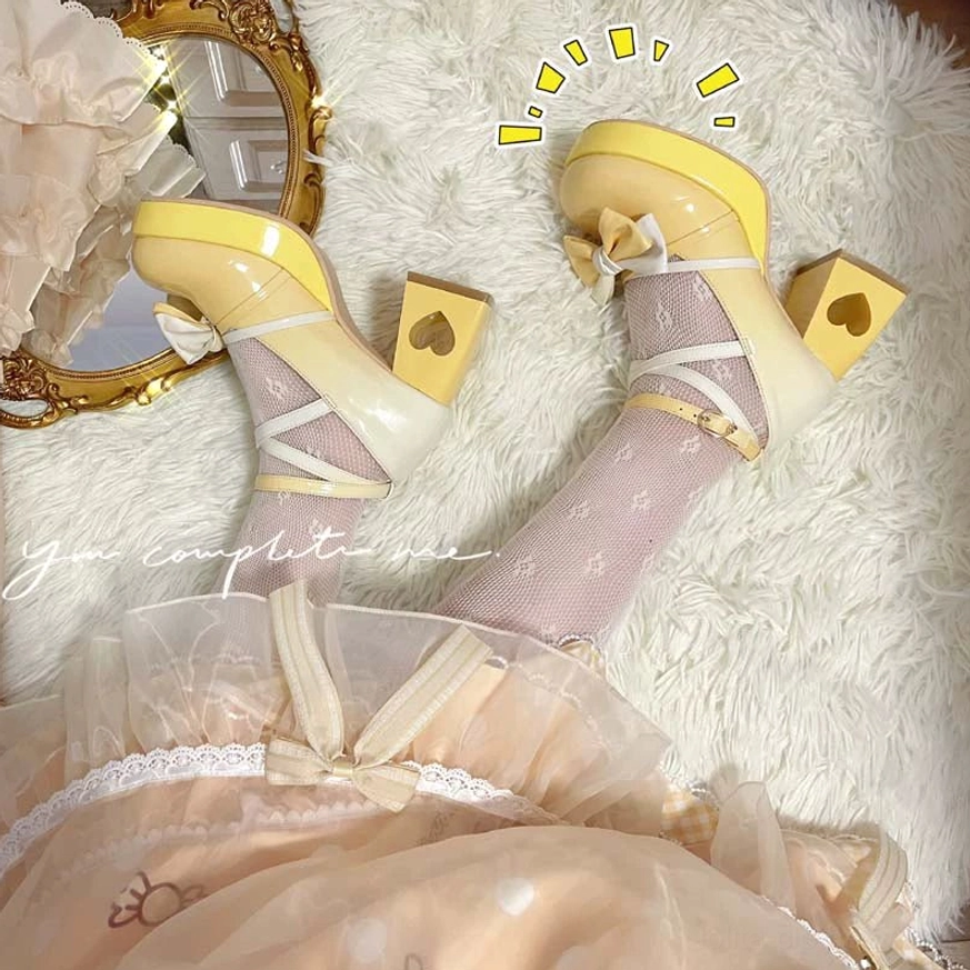 Styled overhead view of worn yellow gradient Lolita heels with heart cutout block heel and cross ankle strap bow, paired with lace-trim sheer socks and Sweet Lolita ruffled dress on fluffy fur rug
