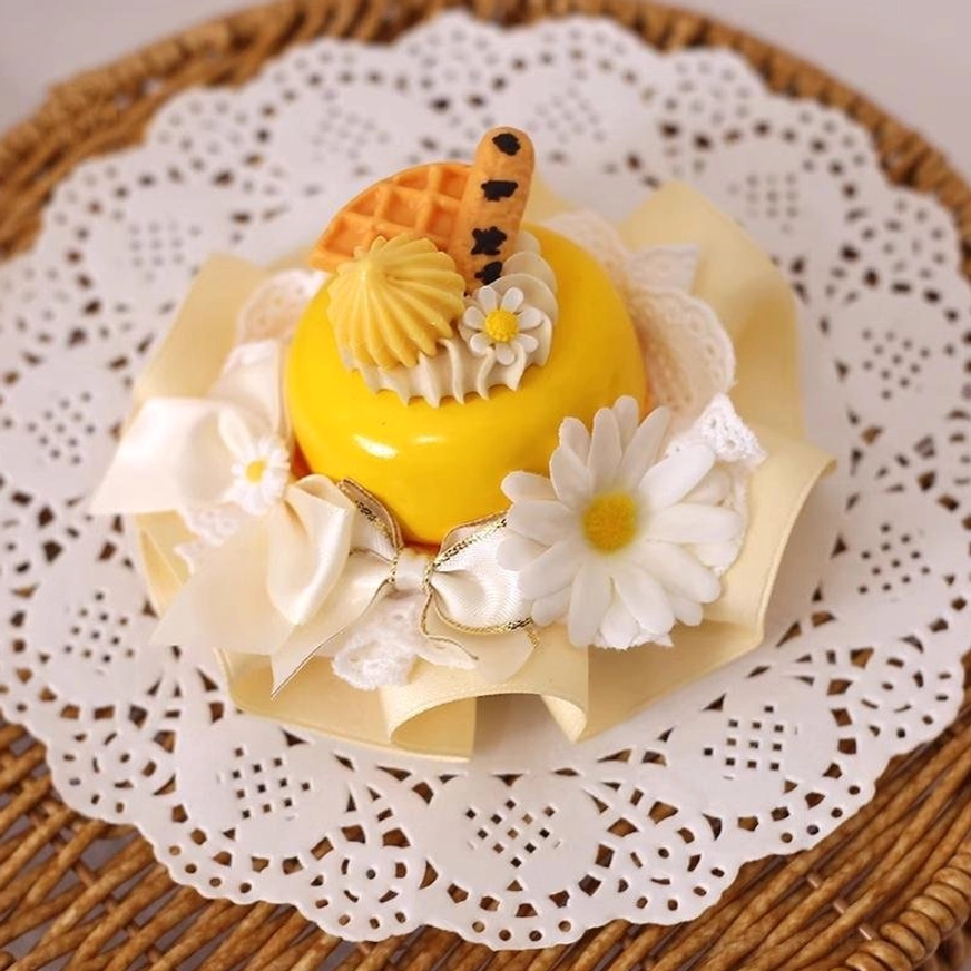 Yellow mousse cake style Lolita hairpin close-up overhead view featuring waffle texture daisy flowers cream and beige fabric bows displayed on white lace doily