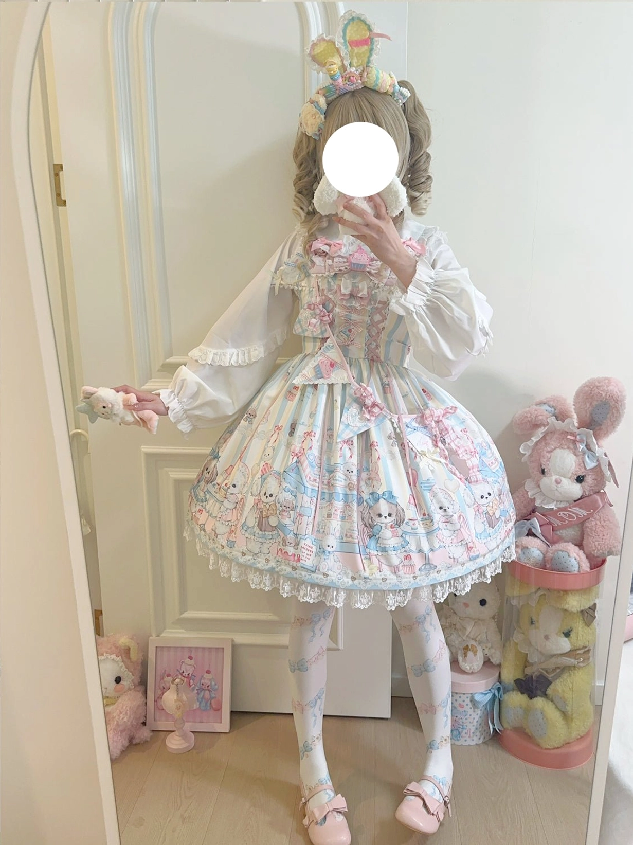 Yellow puppy print Lolita JSK jumper skirt complete coordinate shown in side mirror view with arms open pose, girl wearing bunny hair accessories printed stockings, demonstrating yellow color option