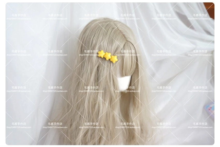 Yellow star hair clip worn in light blonde hairstyle demonstrating real-life wearing effect on lolita hairstyle coordination